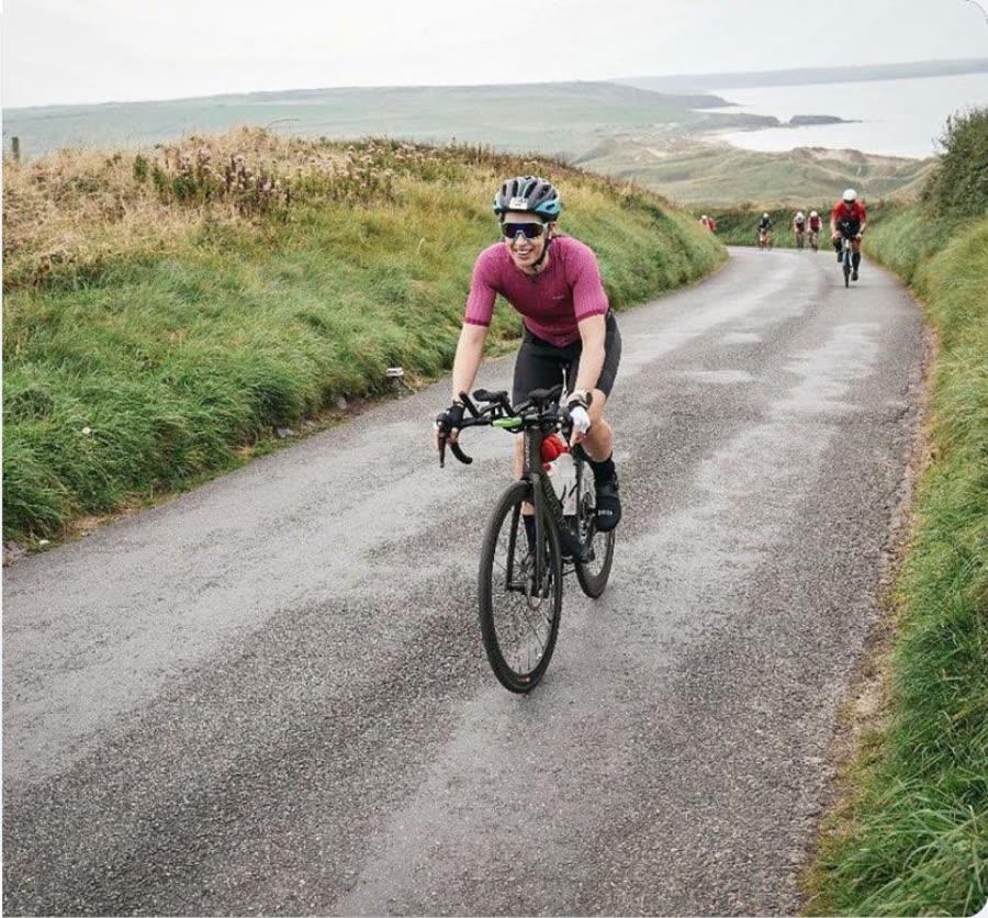 Charlie riding a coastal lane on her bike